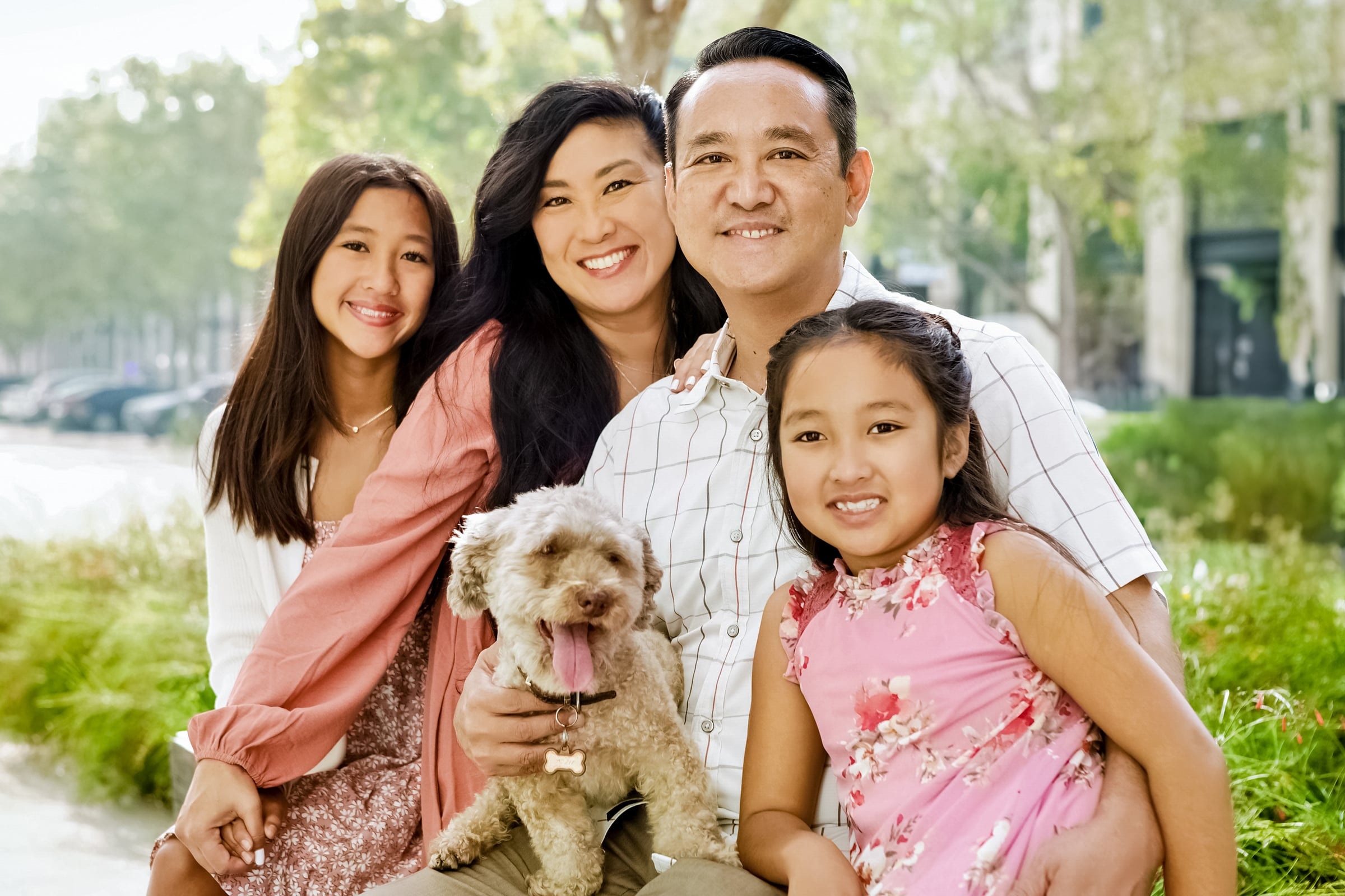 Family enjoying an outdoor portrait session with their dog