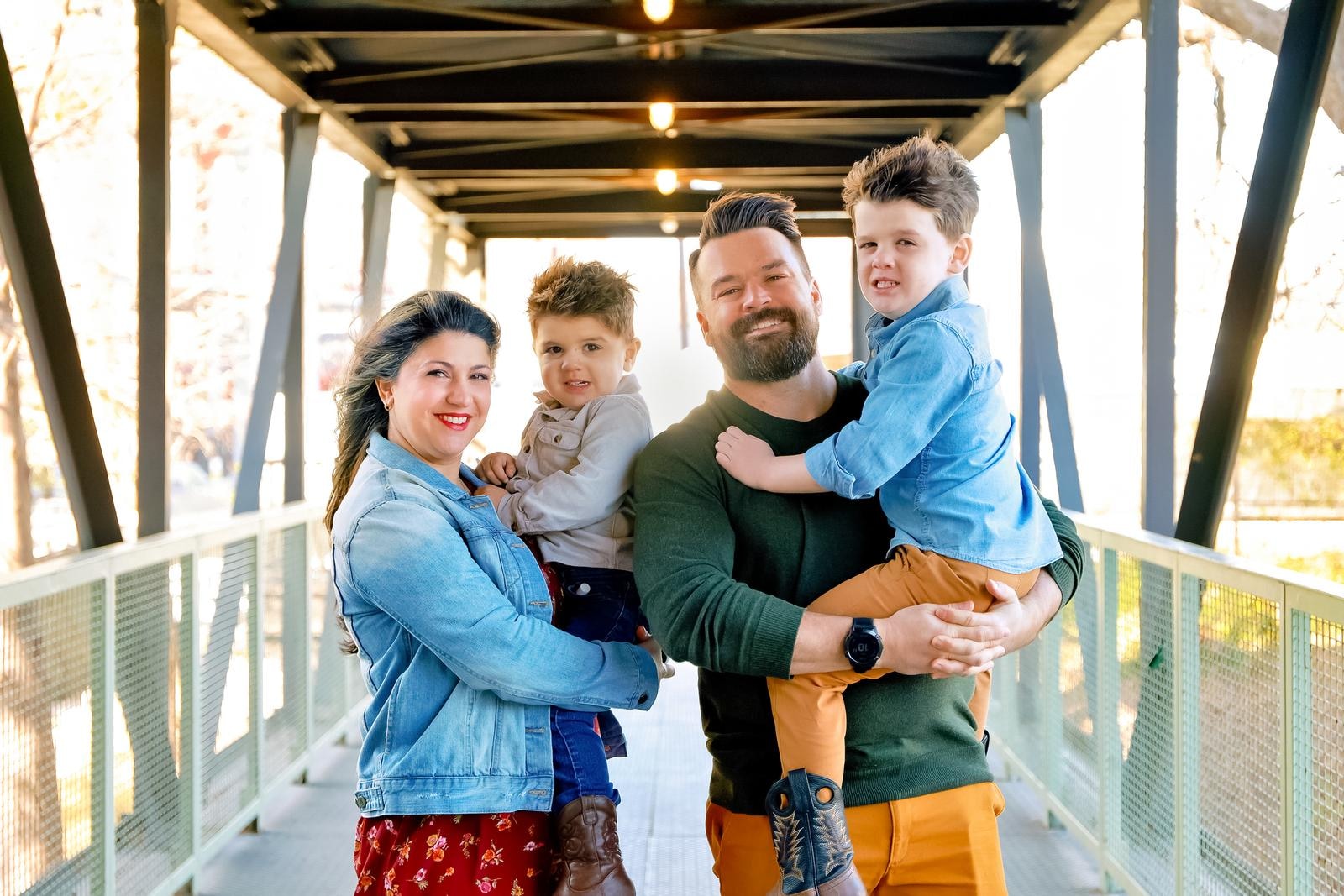 Family enjoying their on-location photo session at golden hour